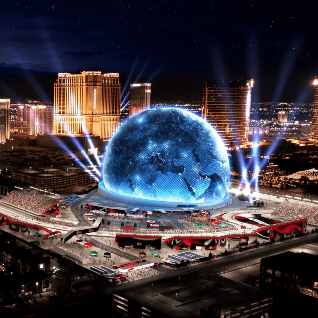 Massive spherical LED display dome with casino skyline in Las Vegas at night, known as MSG.