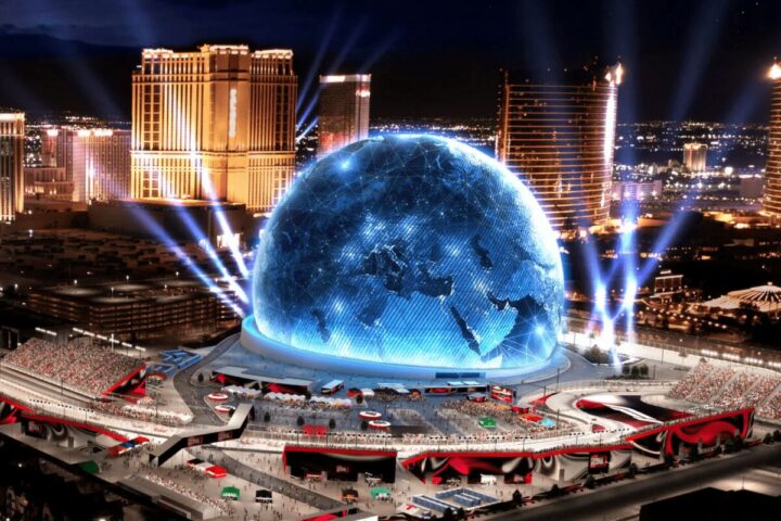 Massive spherical LED display dome with casino skyline in Las Vegas at night, known as MSG.