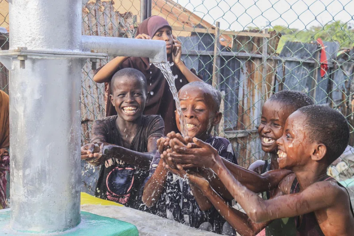 Boys drink water from rehabilitated wells by AMISOM in EL-Ma'an, Bal'ad District of HirShabelle State.