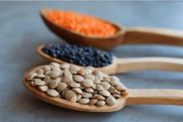 lentils in wooden spoon.