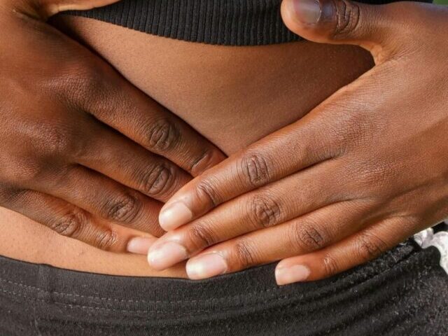 Close-Up Photo of Woman Touching her Abdomen.