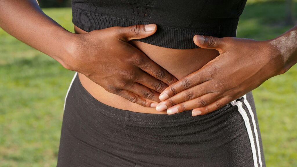 Close-Up Photo of Woman Touching her Abdomen.