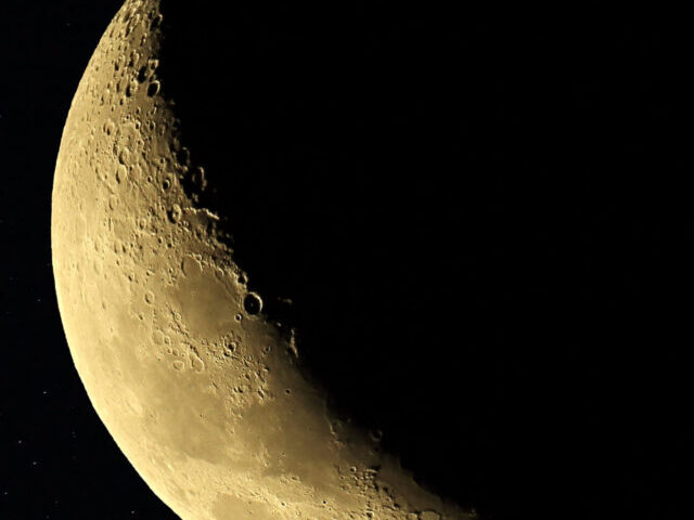 The Moon is shown on a star field in the region of Taurus. Star field taken with a 50mm lens on a Canon 600D.Photo Credit-Kevin Rheese.CC BY 2.0