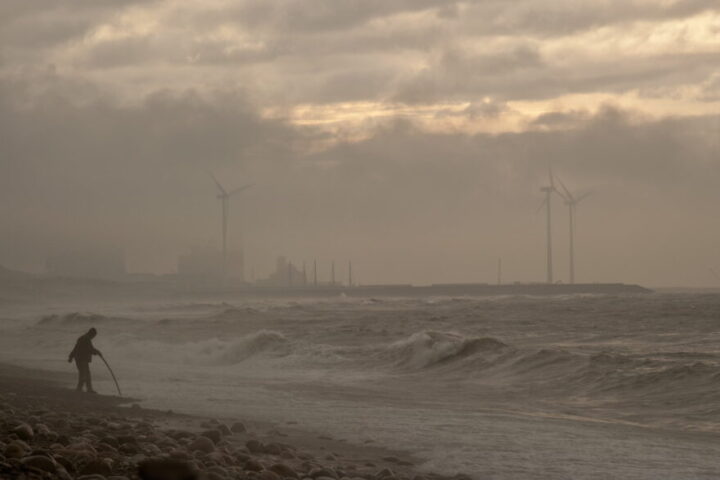 Photo of person walking near sea during noontime.