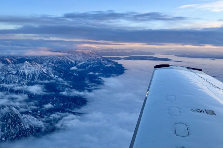 An instrumented Mooney research aircraft passes over the Northern Rocky Mountains in Montana during NOAA’s 2023 NOGAP aerial mission to capture atmospheric profiles of greenhouse gases in a series of flights across the United States. Photo Credits: Anna McAuliffe/CIRES