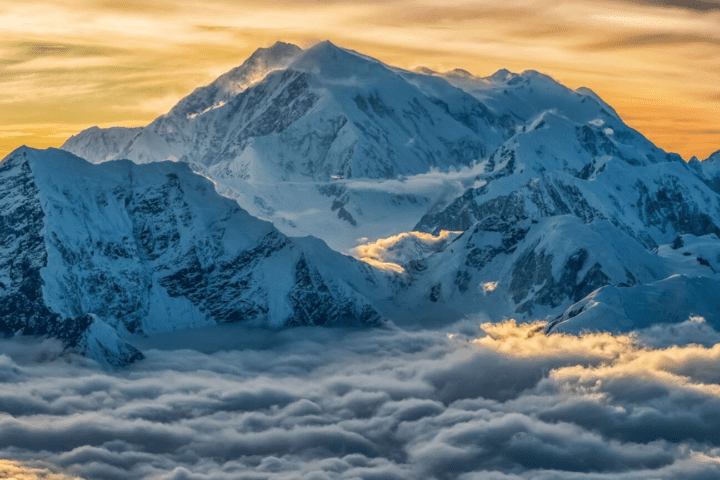 Aerial image of Mount Logan rising above the clouds in Kluane National Park and Reserve, Yukon, Canada