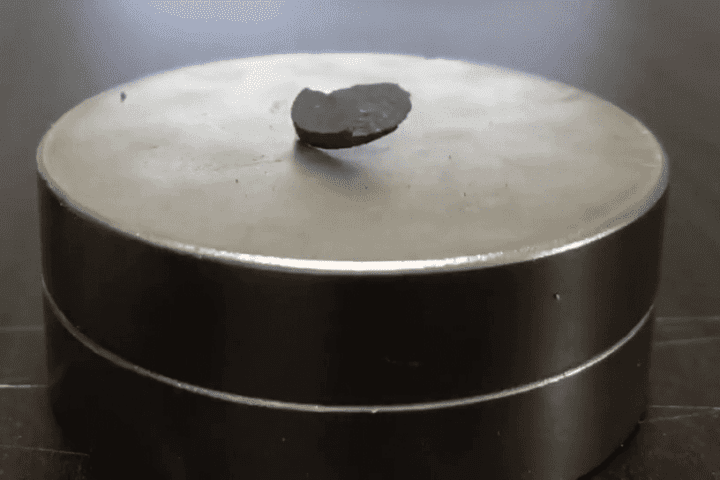 Pellet of LK-99 being repelled by a magnet