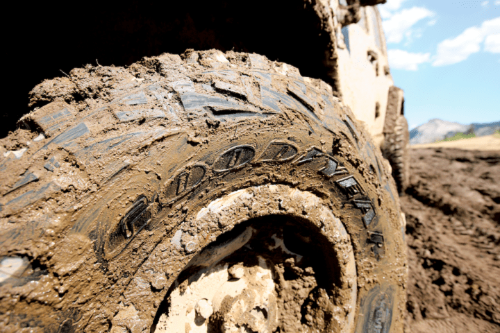 a mud-covered tire bearing the Goodyear logo