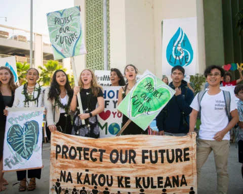 Youth plaintiffs and supporters hold up signs after the Navahine vs the Hawai'i Department of Transportation court hearing in Honolulu, Hawaii on January 26th 2023. Photo Source: Earth Justice