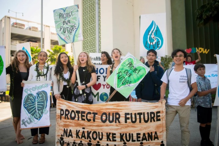 Youth plaintiffs and supporters hold up signs after the Navahine vs the Hawai'i Department of Transportation court hearing in Honolulu, Hawaii on January 26th 2023. Photo Source: Earth Justice