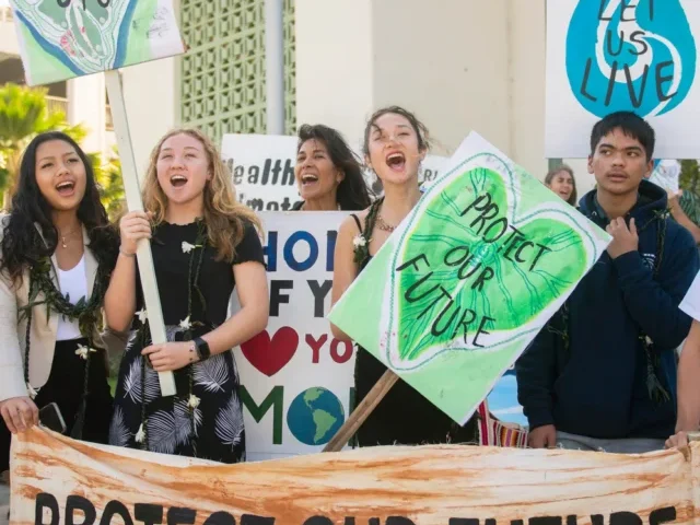 Youth plaintiffs and supporters hold up signs after the Navahine vs the Hawai'i Department of Transportation court hearing in Honolulu, Hawaii on January 26th 2023. Photo Source: Earth Justice