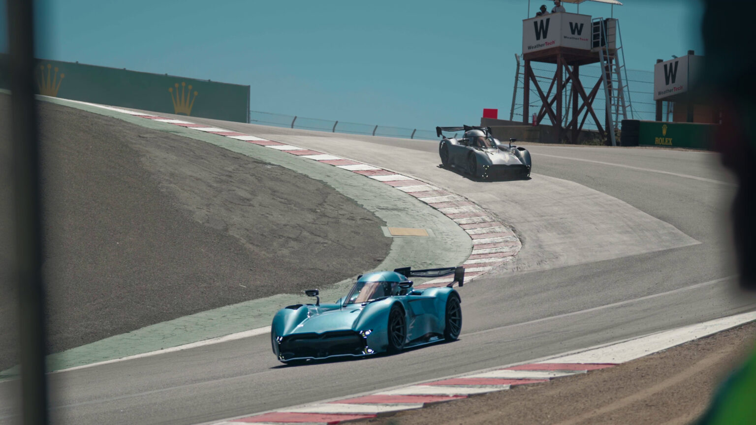 McMurtry showcase two cars running at Laguna Seca during 10 min public display, one accidentally beats EV record.