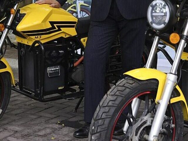 Foreign Secretary James Cleverly looks at a Max NG Electric Vehicles in Lagos, Nigeria.