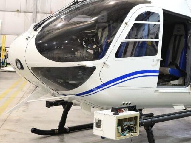 The NASA Airborne Instrumentation for Real-world Video of Urban Environments (AIRVUE) sensor pod is attached to the base of a NASA helicopter at NASA’s Kennedy Space Center in Florida in April 2024 before a flight to test the pod’s cameras and sensors. The AIRVUE pod will be used to collect data for autonomous aircraft like air taxis, drones, or other Advanced Air Mobility aircraft.