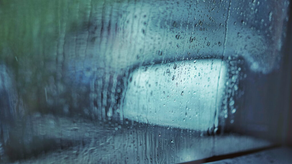 Glass car window with dew.