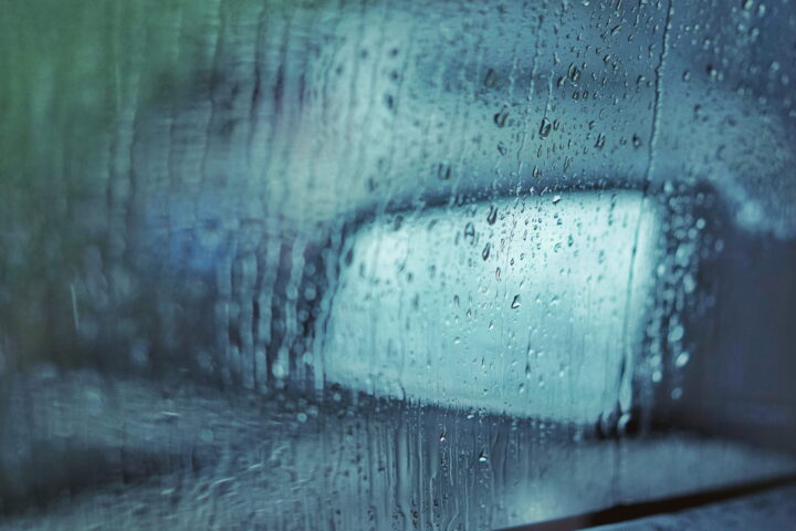 Glass car window with dew.