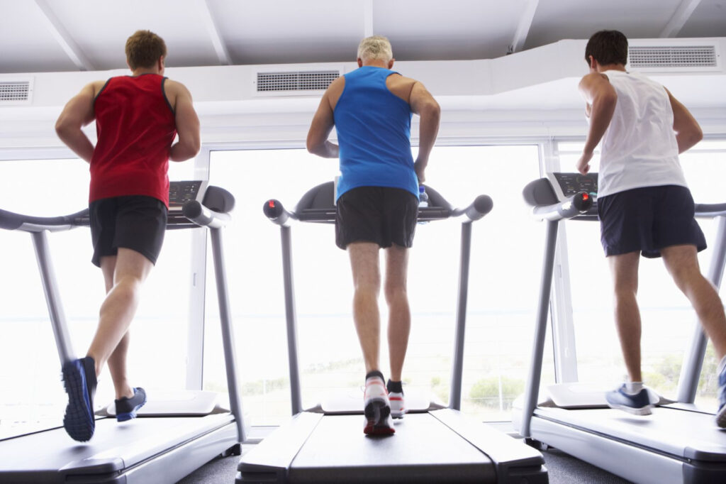 Men running on treadmill.