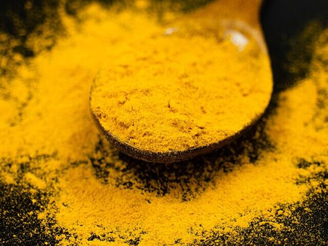 Turmeric Powder on a Spoon.