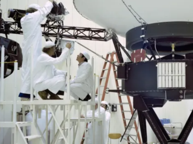 Engineers work on NASA’s Voyager 2 at JPL in March 1977, ahead of the spacecraft’s launch that August. The probe carries 10 science instruments, some of which have been turned off over the years to save power.