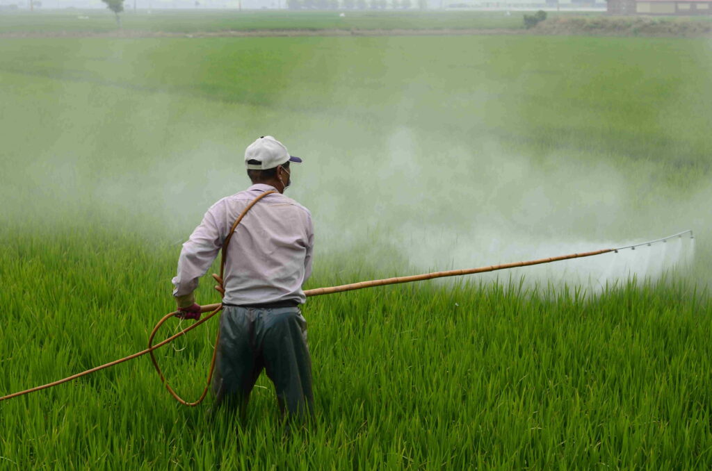 A man holding yellow sprayer.