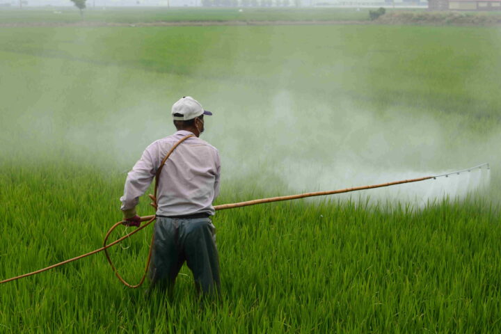 A man holding yellow sprayer.