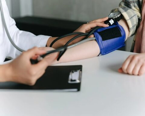 A Healthcare Worker Measuring a Patient's Blood Pressure Using a Sphygmomanometer