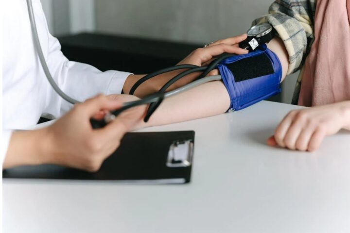 A Healthcare Worker Measuring a Patient's Blood Pressure Using a Sphygmomanometer