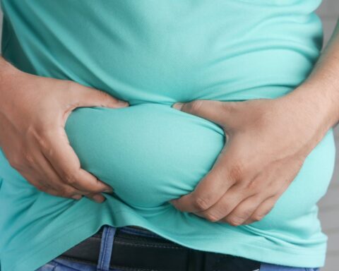 Representative Image. A Person Holding his Belly Fat. Photo Source: Towfiqu barbhuiya (Pexels)