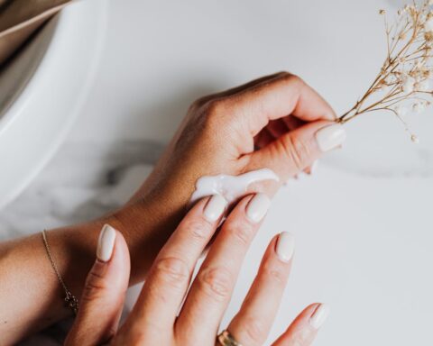 Representative Image. Person applying lotion on hand.