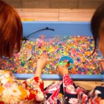 Representative Image. Crop unrecognizable girl washing fishbowl beads in basin. Photo Source: Ryutaro Tsukata (Pexels)