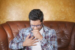 Representative Image. A Man in a Plaid Shirt Coughing. Photo Source: Towfiqu barbhuiya (Pexels)