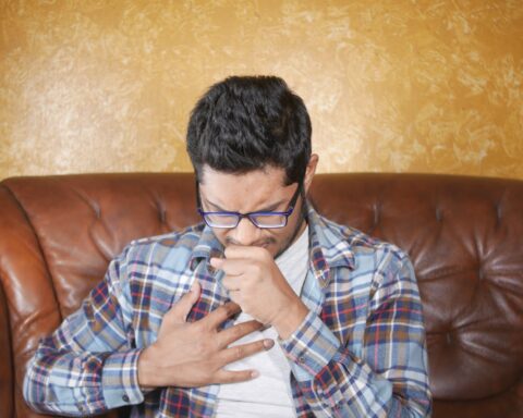 Representative Image. A Man in a Plaid Shirt Coughing. Photo Source: Towfiqu barbhuiya (Pexels)