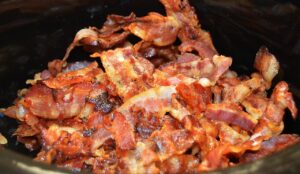 Representative Image. a pile of cooked bacon strips. The bacon appears crispy and well-cooked, with a mix of reddish-brown and golden colors. Source - Pixabay