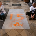 Two climate protesters painted Charles Darwin's grave orange to warn that Earth is getting dangerously hot.