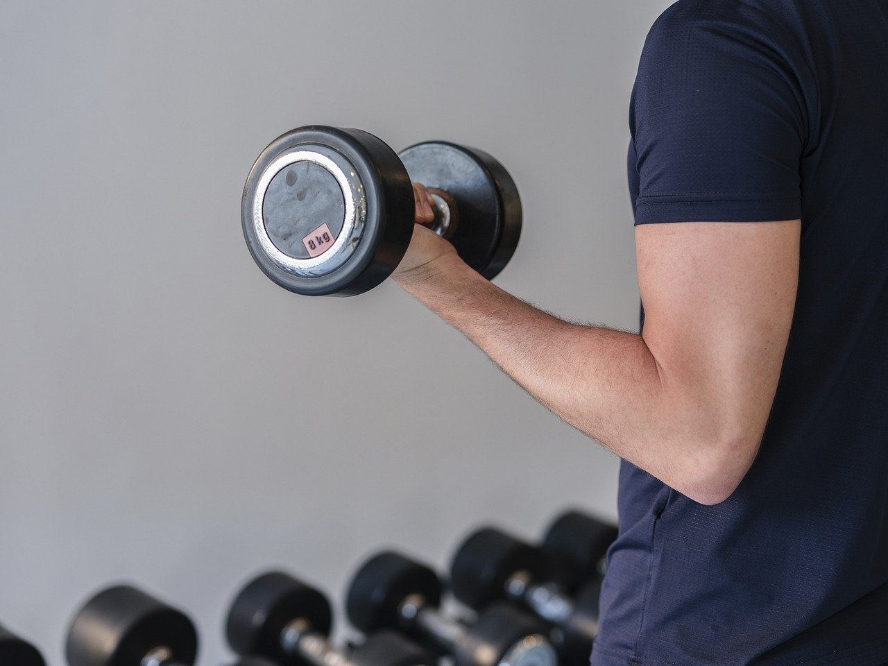 Representative Image. A Person is doing exercise with Dumbell. Photo Source: Engin_Akyurt (Pixabay)