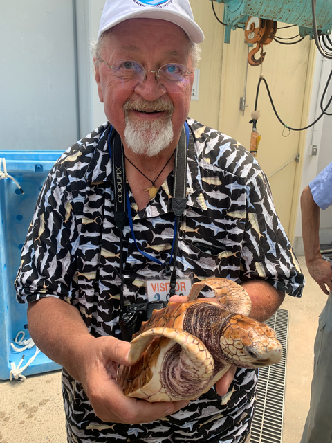 Co-author Larry Crowder poses with a loggerhead sea turtle. Photo Source - Dana Briscode