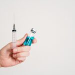 Representative Image. A Person is holding a syringe and a vaccine.(Source-Pexels)