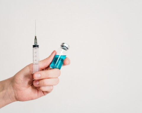 Representative Image. A Person is holding a syringe and a vaccine.(Source-Pexels)