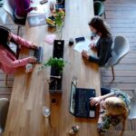 Reprentative Image. Three Woman Sitting on White Chair in Front of Table. Photo Source: Cowomen (Pexels)