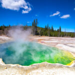 Representative Image. The biggest volcano on the planet is the Yellowstone Caldera. A volcano this size can make lifo on this planet harsh for many years when it erupts. Until that day mud pools and springs where hot water is rising to the surface offer spectacular views.