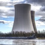 The image shows a large industrial structure, likely cooling towers of a power plant, Photo Source: Pixabay