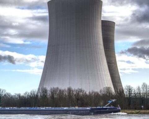 The image shows a large industrial structure, likely cooling towers of a power plant, Photo Source: Pixabay