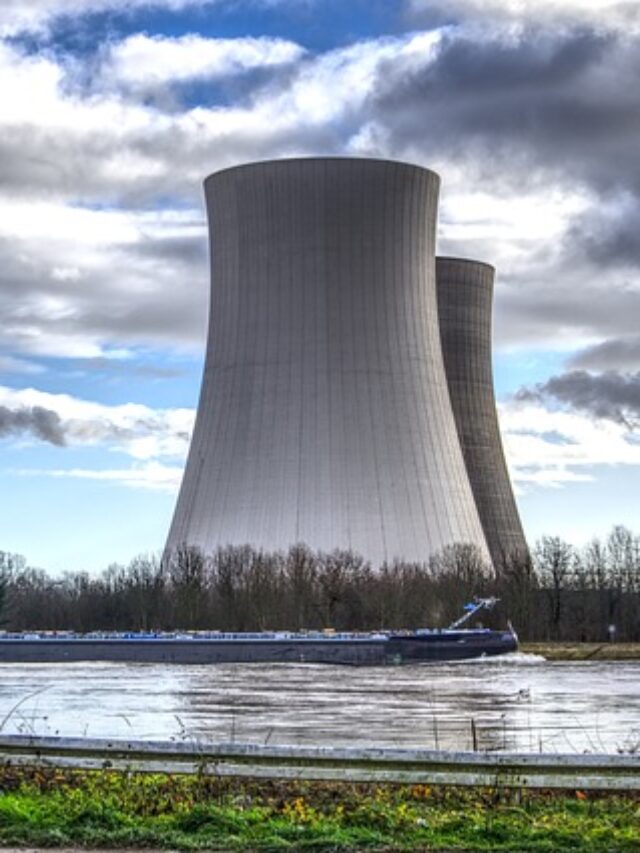 The image shows a large industrial structure, likely cooling towers of a power plant, Photo Source: Pixabay