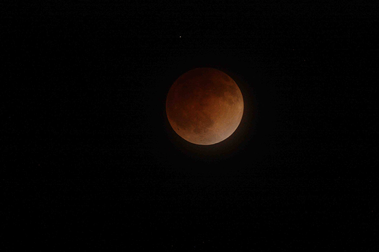 A blood moon against the night sky in 2014. Photo Source: NASA Ames Research Center/Brian Day