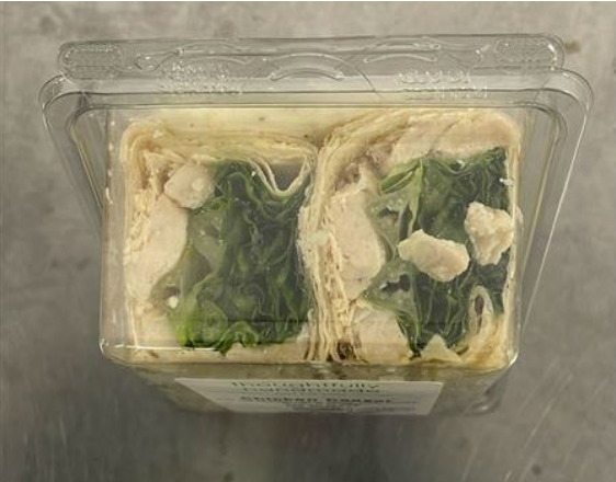 A plastic container with two wraps inside. Photo Source - USDA