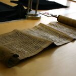 Representative Image. An ancient scroll laid out on a wooden table. Photo Source - Ooligan (CC BY-SA 2.0)