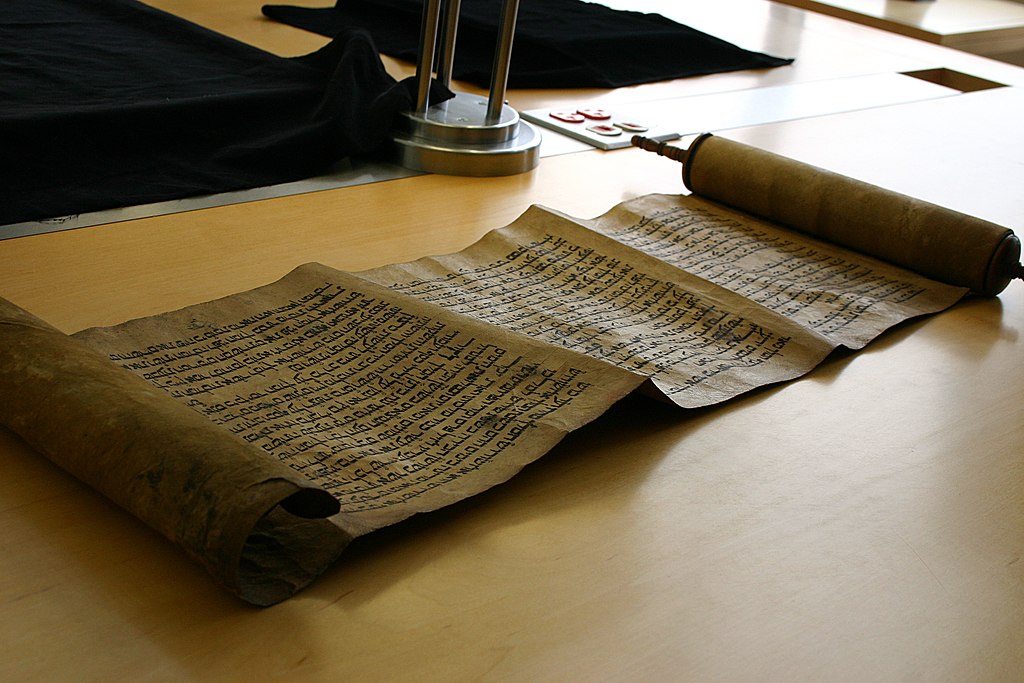 Representative Image. An ancient scroll laid out on a wooden table. Photo Source - Ooligan (CC BY-SA 2.0)