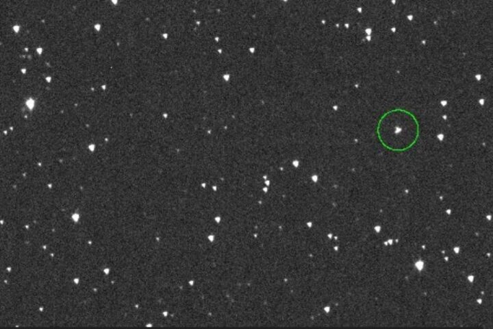 A telescope-captured view of space showing multiple stars or celestial objects. A particular object is highlighted with a green circle, which likely represents the asteroid 2024 YR4. Photo Source: NASA