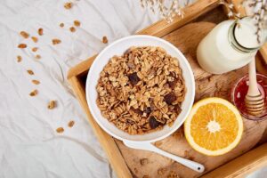 Representative image: Healthy breakfast muesli, milk, orange, and honey on a tray. Photo Source: bangalore digital marke