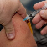 Representative Image: Person holding syringe while injected to skin. Photo Source: PickPik